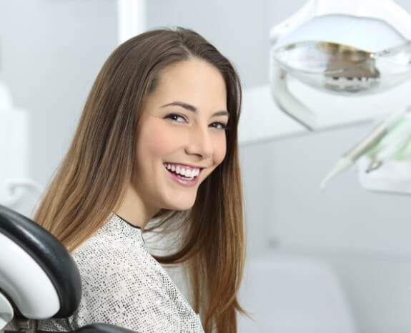 Woman smiling after same day emergency dentistry treatment