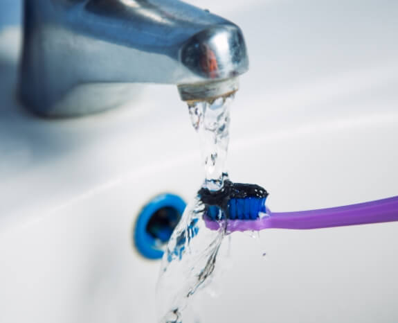 Toothbrush with fluoride treatment paste