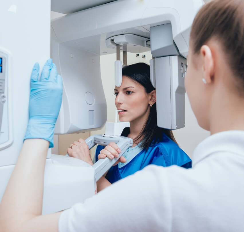 Woman receiving 3 D C T cone beam digital x ray scans