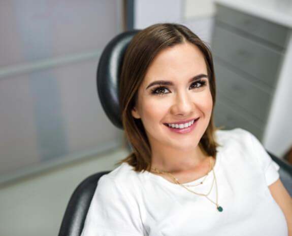 Smiling woman enjoying the benefits of tooth colored fillings
