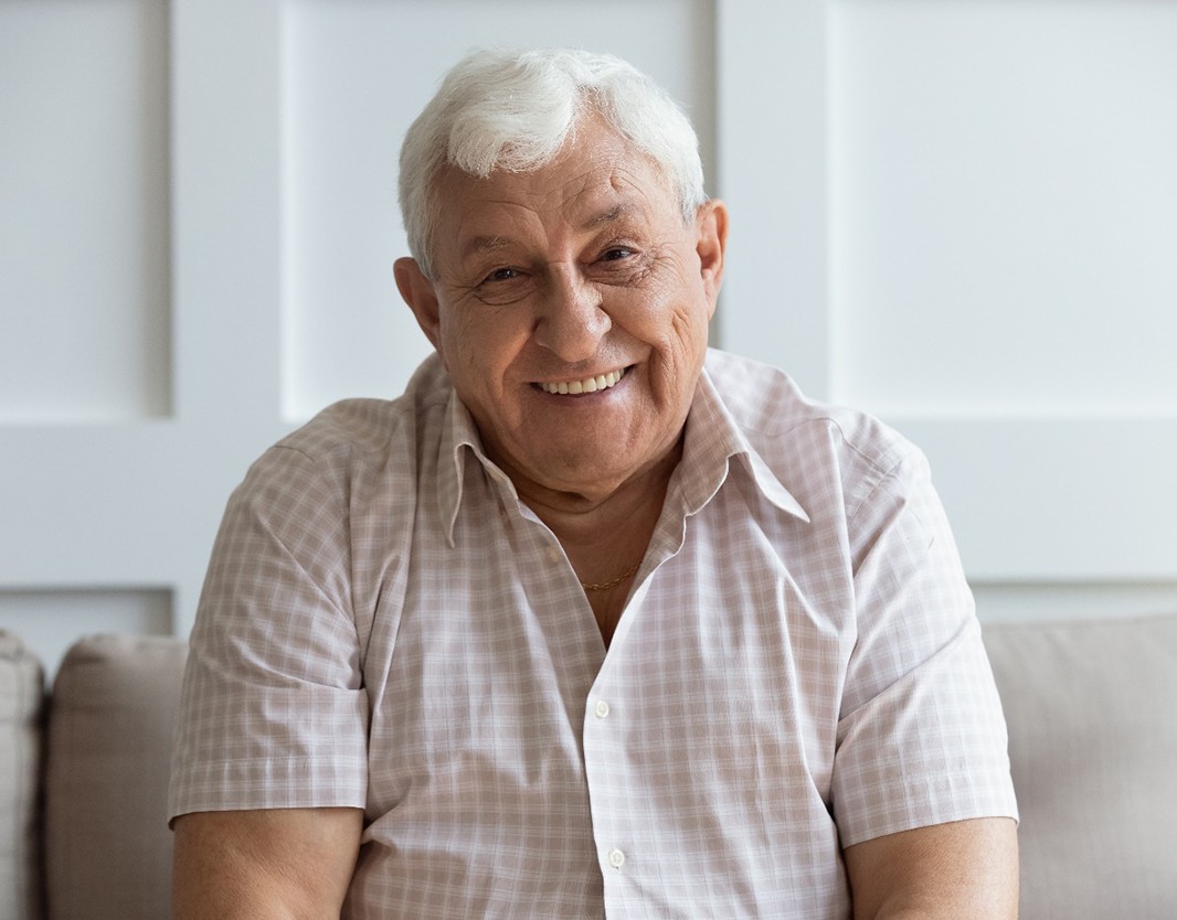 happy mature man with implant dentures in Plano