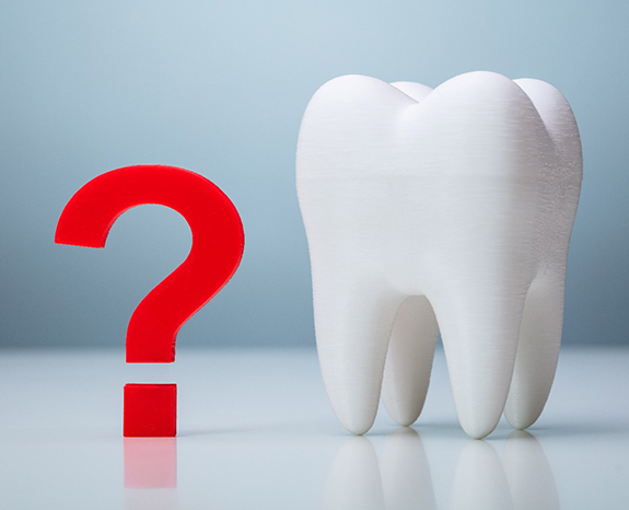 A red question mark near a giant model tooth