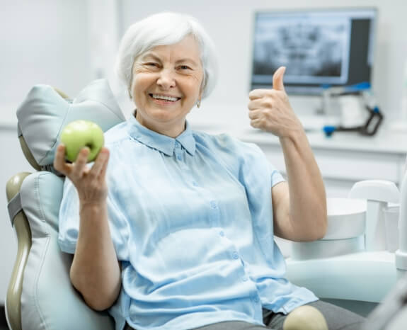Woman smiling and giving thumbs up