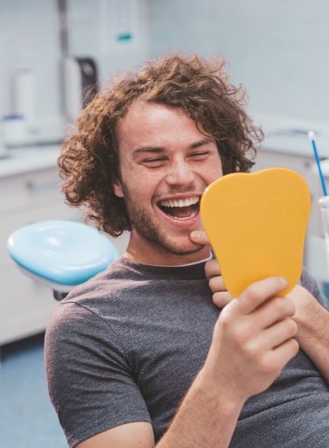 Man in dental chair smiling