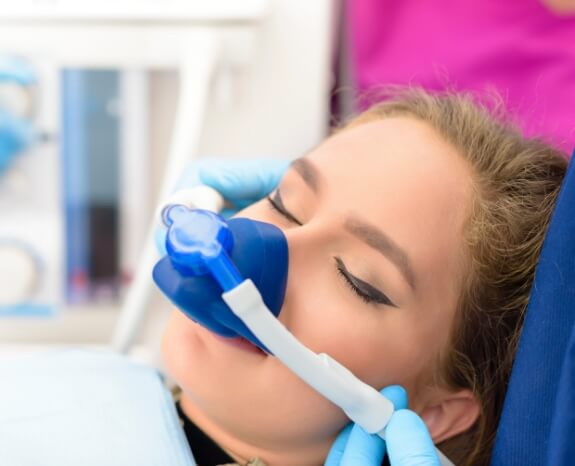 Woman receiving nitrous oxide sedation dentistry treatment