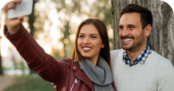 Man and woman smiling together after preventive dentistry visit