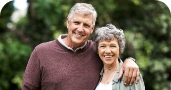 Man and woman with healthy smiles thanks to restorative dentistry