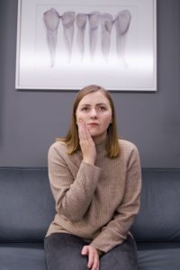 Woman with dental pain waiting at emergency dentist